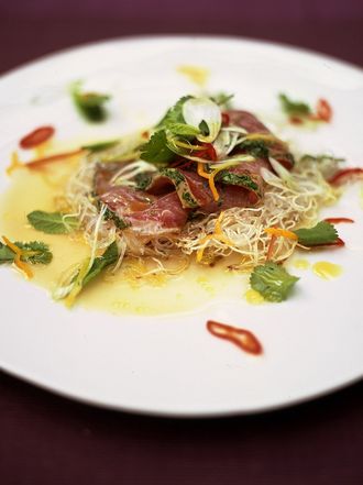 Citrus-seared tuna with crispy noodles, herbs and chilli
