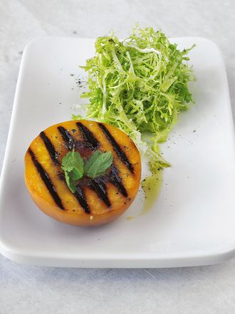 Warm grilled peach & frisée salad with goat's cheese dressing