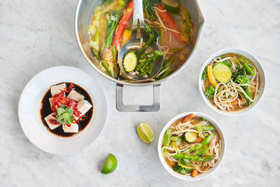 Pot and bowls of vegetarian noodle soup